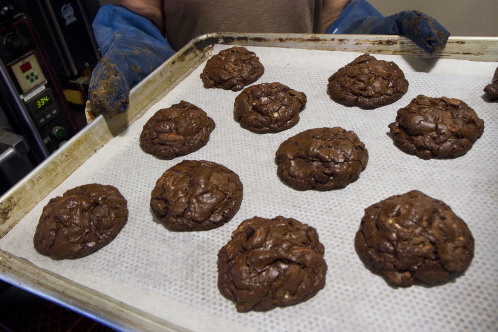 Chunky chocolate rye cookies, made with Maine-grown rye, are put into a rack to cool at Standard Baking Co. in Portland. 