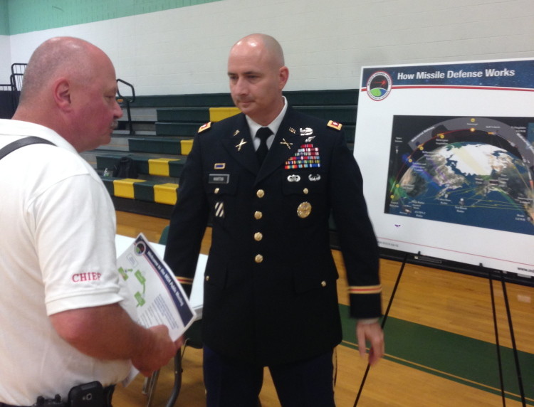 Rangeley Fire Chief Tim Pellerin, left, speaks with Lt. Col. Dan Martin at a public meeting on the potential environmental effect of a missile interceptor facility in Redington Township.