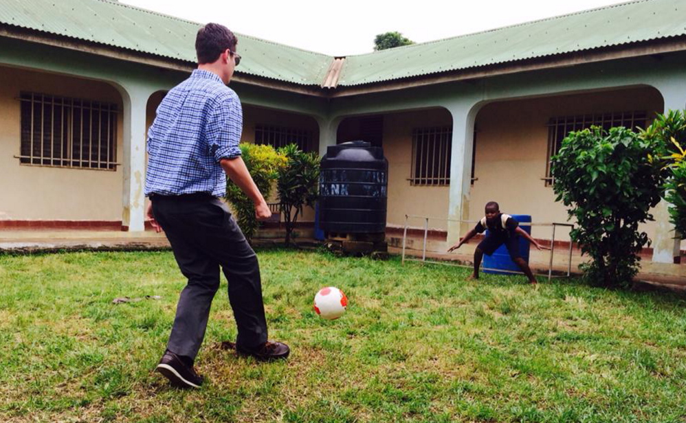 Gradi Schutt plays soccer with a child in Sierra Leone this summer. He hopes to return once the Ebola outbreak has passed.
