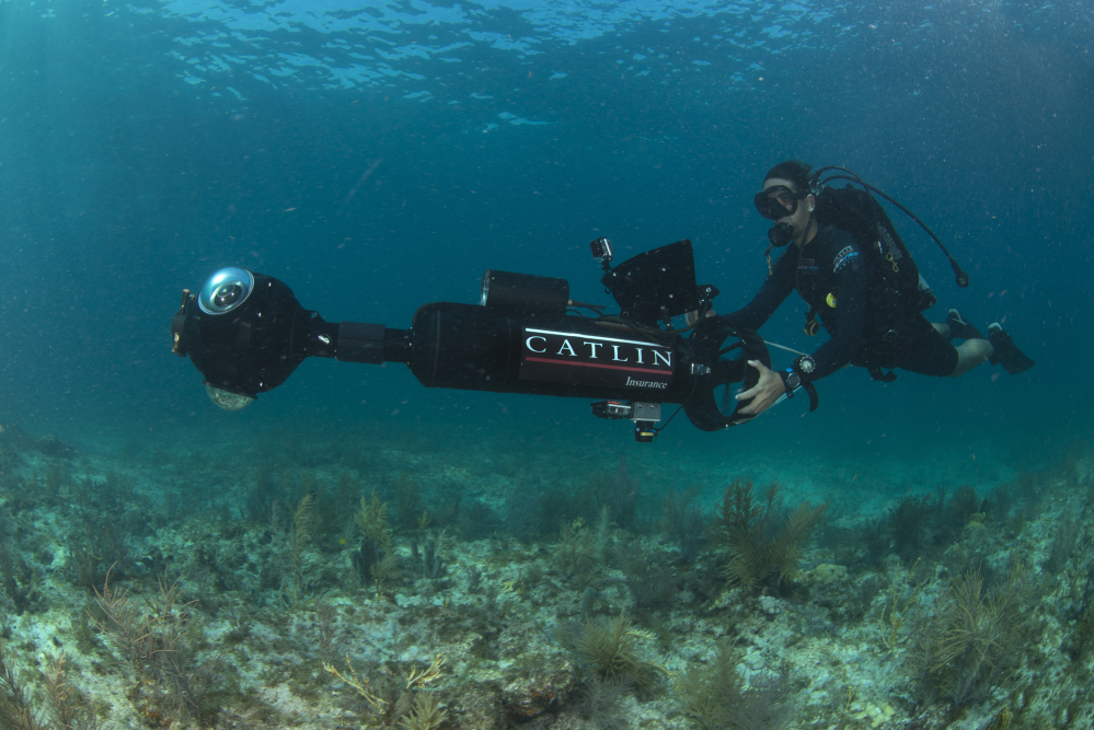 In this Aug, 9, 2014 photo provided by Catlin Seaview Survey, Catlin’s Manuel Gonzalez surveys an area underwater in Key Largo, Fla. U.S. government scientists hope people will soon be able to go online and get a 360-degree view of reefs and other underwater wonders, much like Google Map’s “street view” lets people look at homes.
