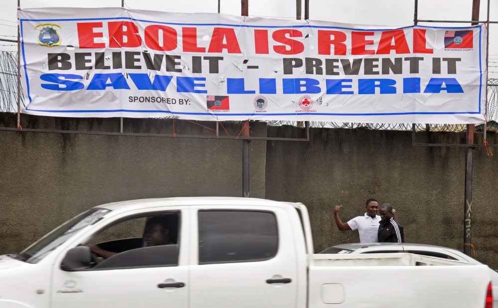 In this image taken Saturday, a  banner  adorns a street as the deadly Ebola virus spread in Monrovia, Liberia.