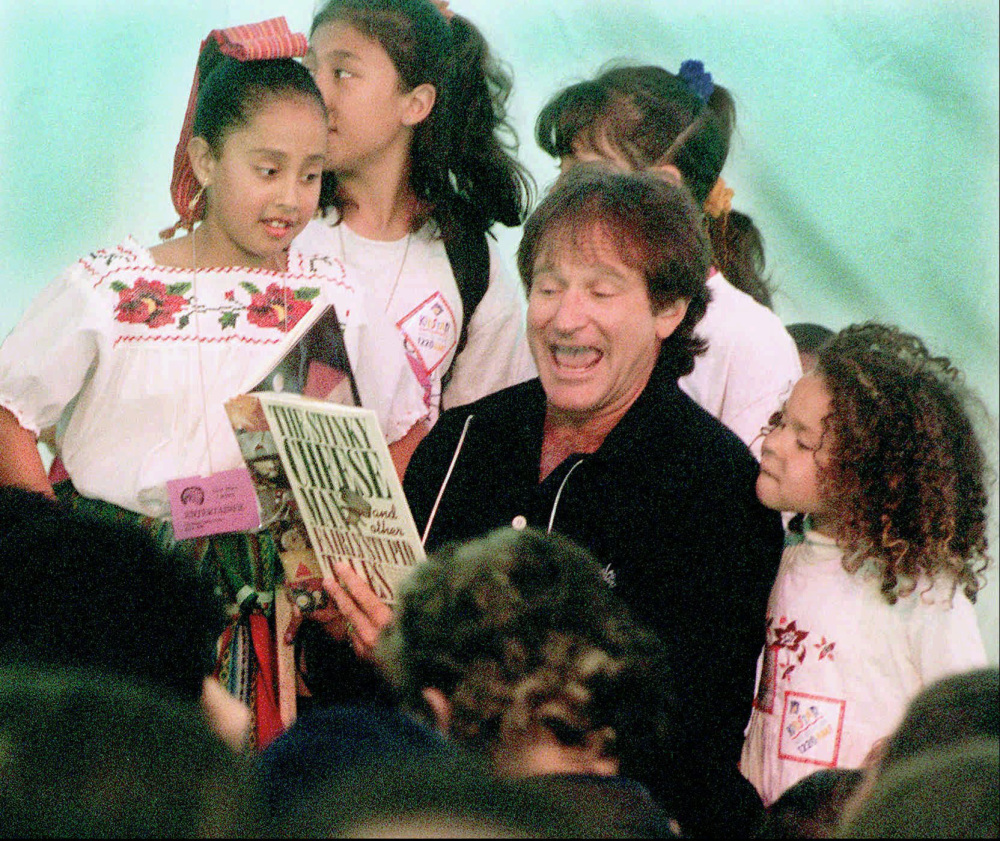 Robin Williams reads to children to help inaugurate the main library in San Francisco in 1996. From jogging to visiting hospitals, he made himself a part of the fabric of life there.