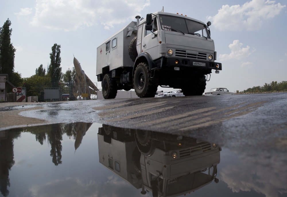A truck moves out from the military base not far from Voronezh, Russia, on Wednesday. Russia dispatched some hundreds of trucks covered in white tarps and sprinkled with holy water on a mission to deliver aid to a rebel-held zone in eastern Ukraine.