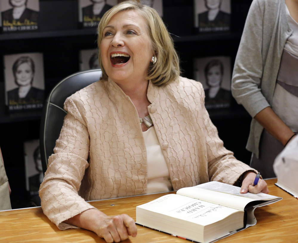 Former Secretary of State Hillary Rodham Clinton laughs while speaking with a customer at a signing for her book “Hard Choices,” at Bunch of Grapes Bookstore, Wednesday in Vineyard Haven, Mass. 