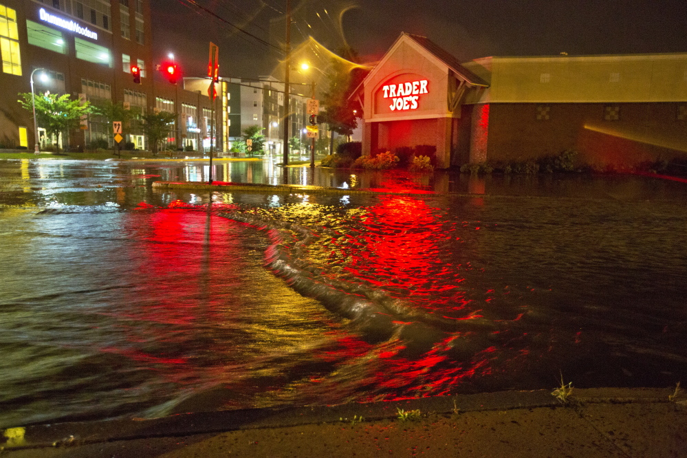 Floodwaters engulf Preble Street near the Trader Joe’s store on Marginal Way in Portland after heavy rains last August. Much of the Bayside neighborhood is located in a flood zone because of its low elevation. 
