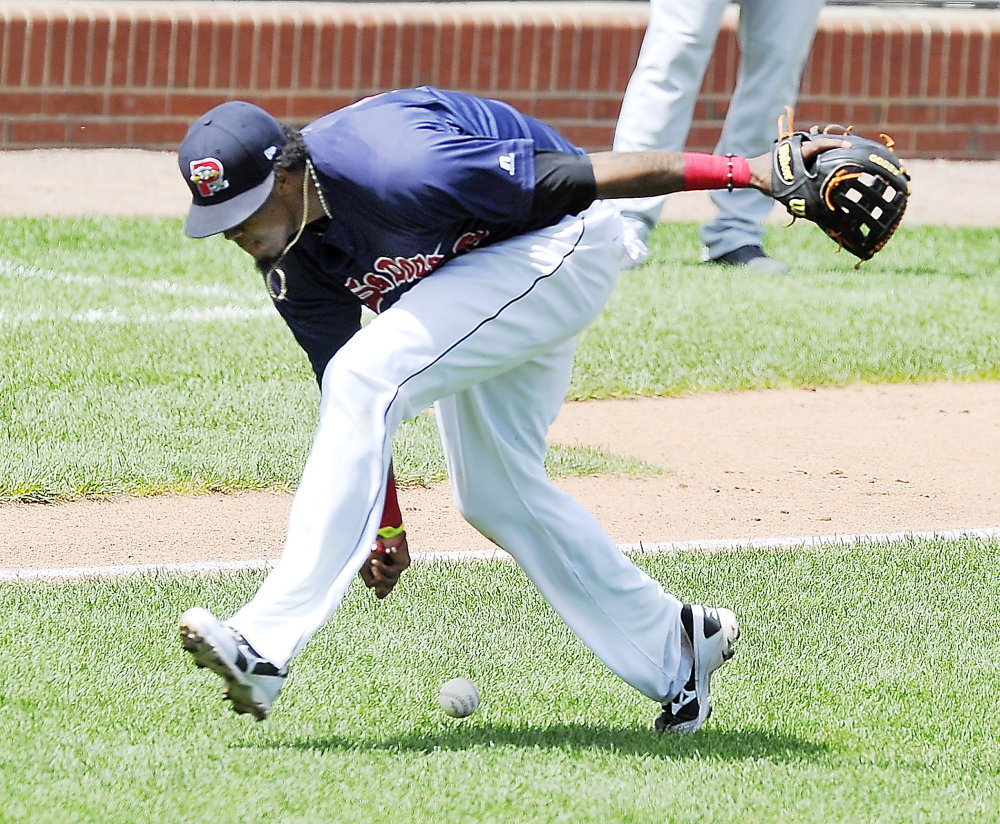 Third baseman Michael Almanzar of the Portland Sea Dogs attempts to barehand a grounder that went for a single Thursday during the first game of a doubleheader loss to the Akron RubberDucks at Hadlock Field. Portland was swept in the three-game series at home.