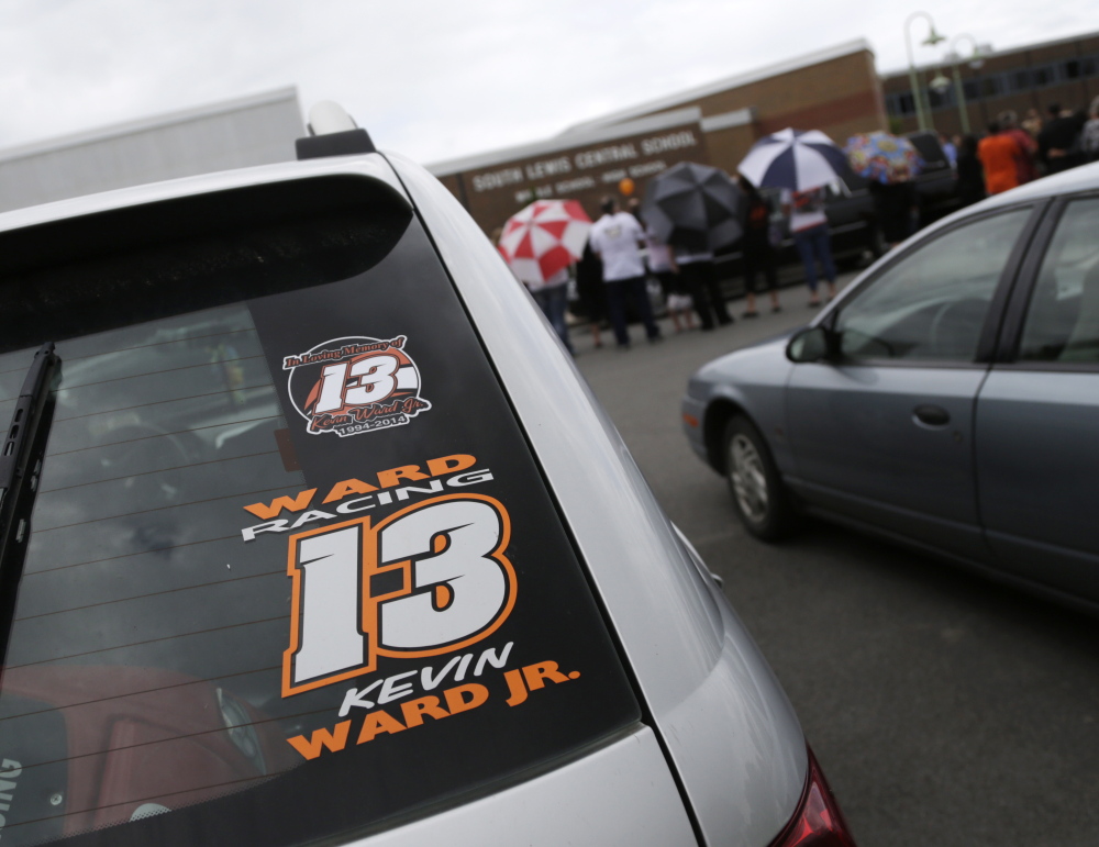 A Kevin Ward Jr. racing sticker is displayed on a vehicle outside South Lewis Central School after a funeral on Thursday, Aug. 14 in Turin, N.Y. Ward died after being struck by NASCAR driver Tony Stewart’s car during a race last weekend at a dirt track in western New York.