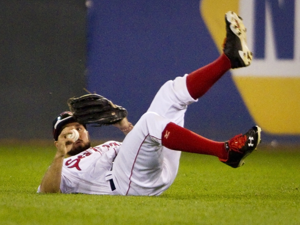 Sea Dogs right fielder Kevin Heller rolls to his feet after missing a diving catch against the Richmond Flying Squirrels at Hadlock Field in Portland. Carl D. Walsh/Staff Photographer