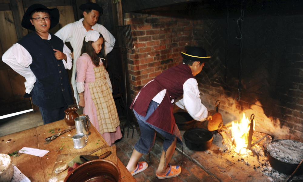 International students learn how to bake a blueberry pie in an open hearth with an artist from the Pocumtuck Valley Memorial Association at the Indian House Children’s Museum in Old Deerfield, Mass. The learning experience for children from China, Japan, South Korea and Kazakhstan is part of the Bement School’s English Immersion summer program.