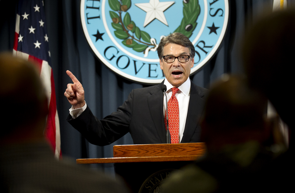 Gov. Rick Perry makes a statement in Austin, Texas, on Saturday concerning his indictment on charges of coercion of a public servant and abuse of his official capacity. Perry is the first Texas governor since 1917 to be indicted. The Associated Press