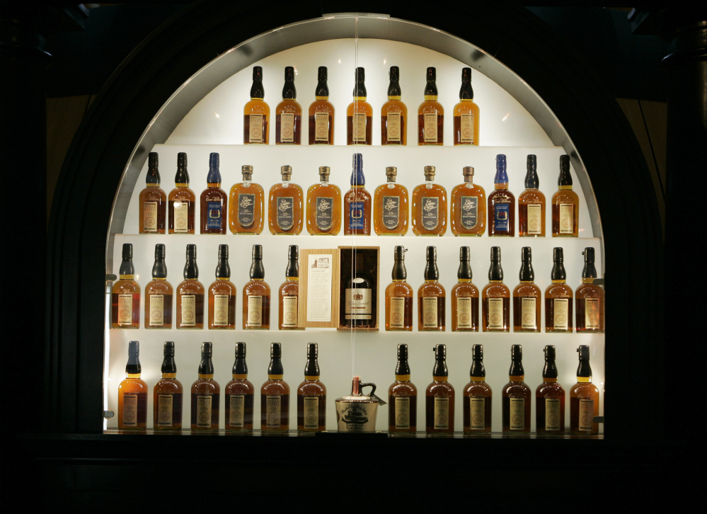 Bottles of bourbon are on display in a case at the Heaven Hill Bourbon Heritage Center in Bardstown, Ky. Kentucky bourbon makers have stashed away their largest stockpiles in more than a generation due to resurgent demand.