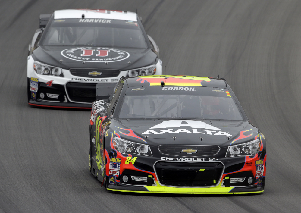 Jeff Gordon (24) races Kevin Harvick in the NASCAR Sprint Cup Series Pure Michigan 400 auto race at Michigan International Speedway in Brooklyn, Mich., on Sunday.