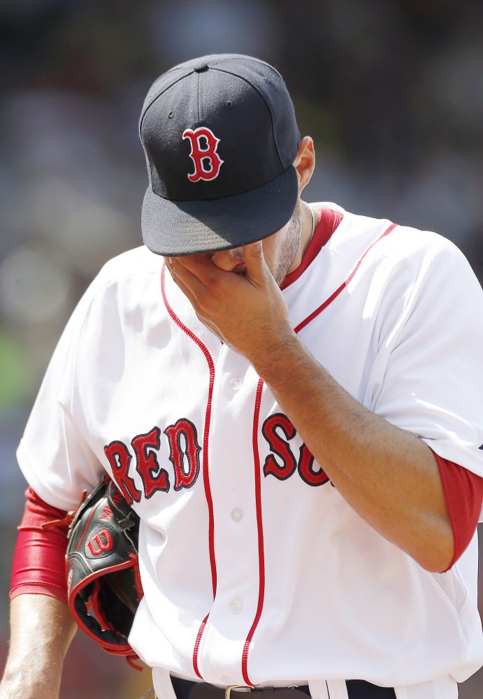 Boston Red Sox’s Joe Kelly walks to the dugout after giving up six runs to the Houston Astros during the second inning of a baseball game in Boston, Sunday.