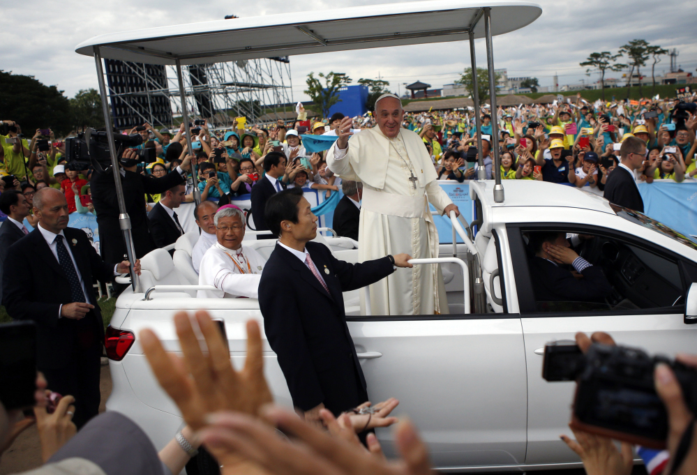 Pope Francis waves as he arrives for a closing Holy Mass of the 6th Asian Youth Day at Haemi Castle in Haemi, South Korea, on Sunday. He also urged the region’s bishops to engage with people empathetically.