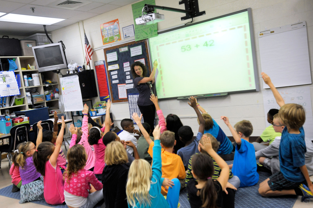 Third-grade teacher Melissa Grieshober teaches a math lesson at Silver Lake Elementary School in Middletown, Del., in 2013. Scientists have put youngsters into brain scanners to watch how the brain reorganizes itself as kids learn math.
