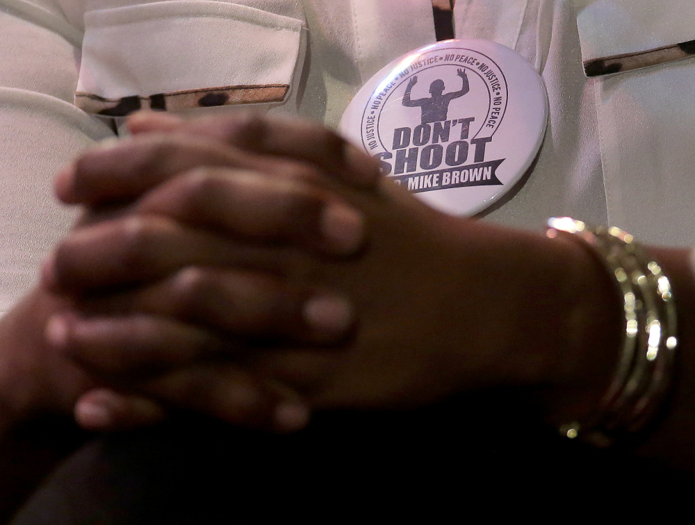 Michael Brown’s mother,  Lesley McSpadden, wears a don’t shoot button during a rally at Greater Grace Church, Sunday, for their son who was killed by police last Saturday in Ferguson, Mo.