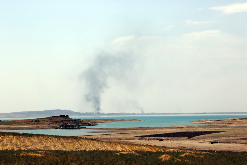 Smoke rises during airstrikes targeting Islamic State militants at the Mosul Dam outside Mosul, Iraq, Monday.