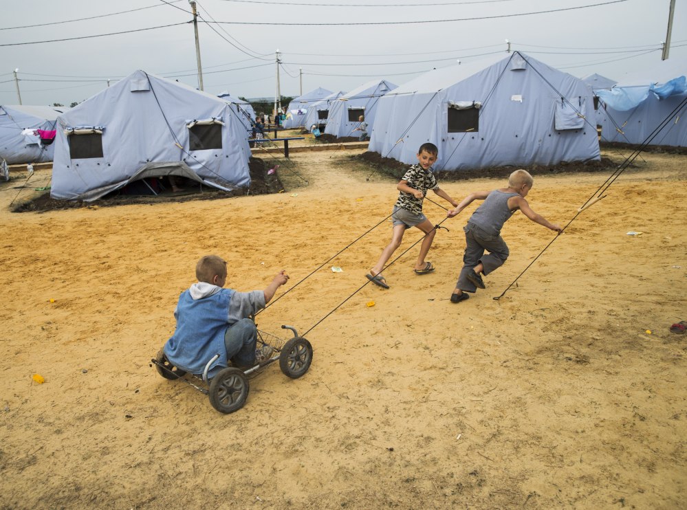 Several boys play Monday in a refugee camp near the border set up by the Russian Emergencies Ministry for people displaced by the fighting in Ukraine.