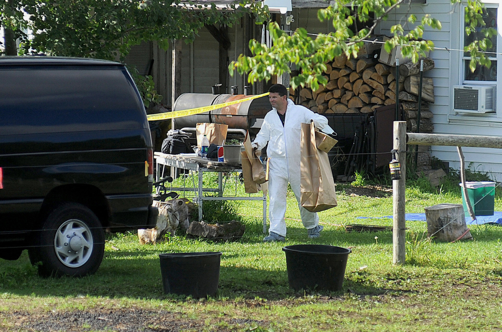 A New York State Police crime scene investigator carries evidence to a van Sunday at the home of suspected kidnappers Stephen Howells Jr. and Nicole Vaisey, in Hermon, N.Y. The father of two Amish girls abducted in northern New York last week says he feels sorry for the two people authorities say kidnapped and sexually abused his daughters.