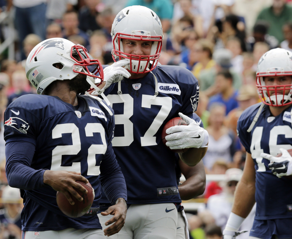 Two injury-filled seasons haven’t dampened the passion of Patriots’ tight end Rob Gronkowski (87) as he laughs it up with running back Stevan Ridley during training camp.