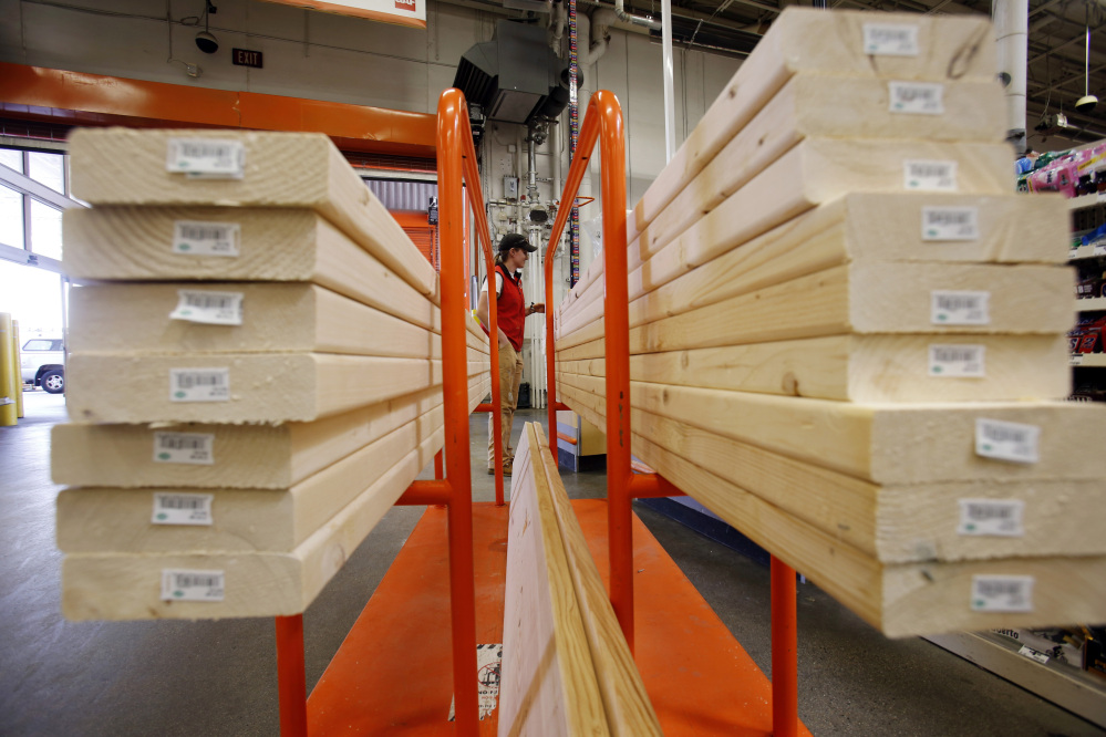 A shopper checks out with her lumber at a Home Depot in Boston in May 2014.
