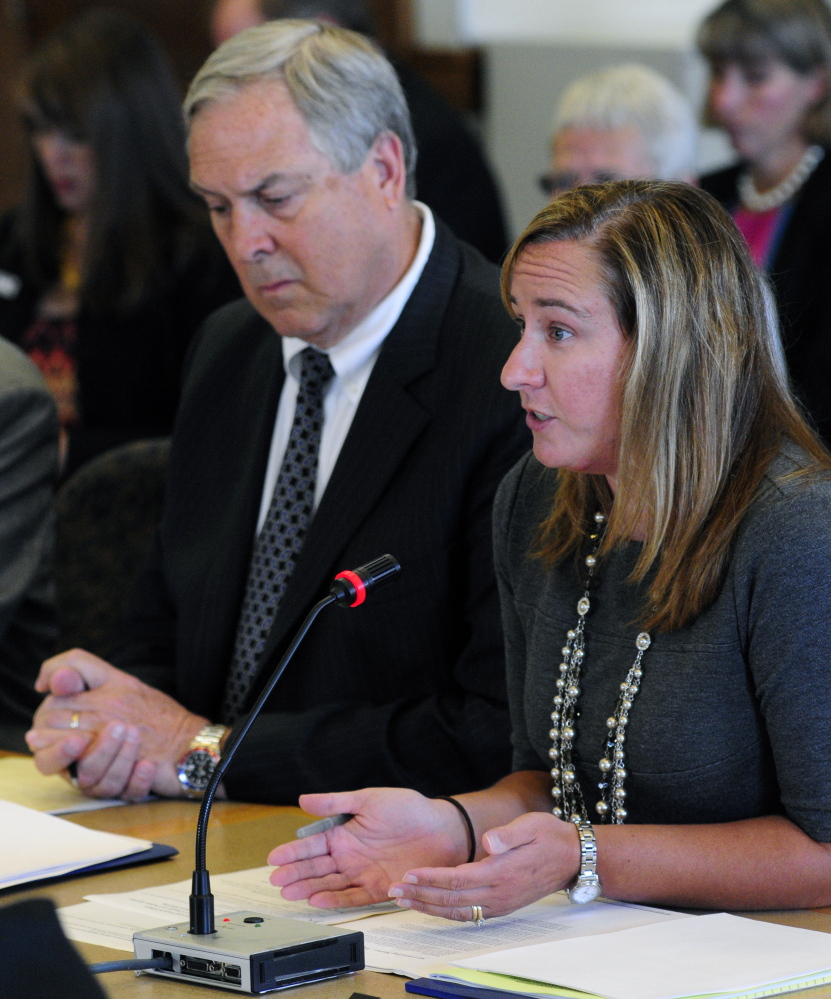 Ricker Hamilton, deputy commissioner for programs, left, listens as Stefanie Nadeau, director of MaineCare Services, answers questions Tuesday during a meeting of the Appropriations and Financial Affairs Committee with the Health and Human Services Committee in the State House in Augusta.