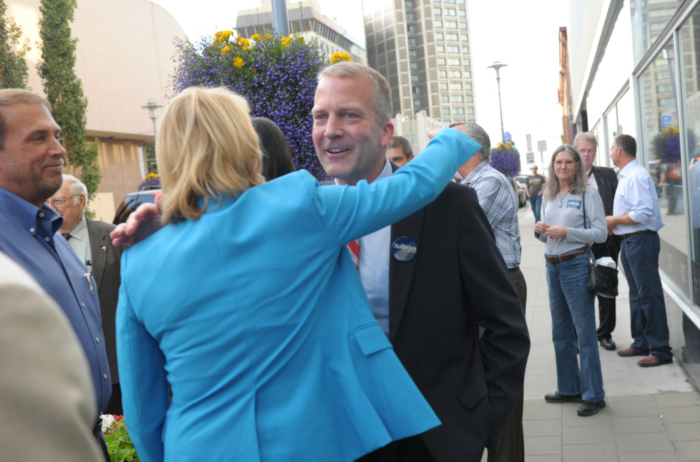 Republican U.S. Senate candidate Dan Sullivan receives a hug from a supporter in downtown Anchorage.