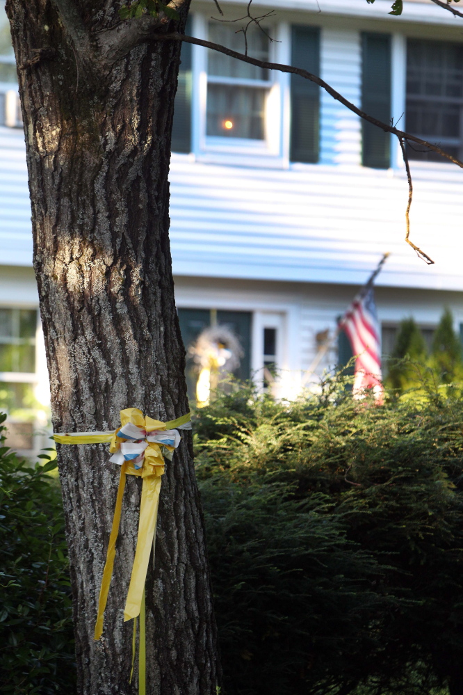 A ribbon is tied to a tree outside the home of American freelance journalist James Foley on Tuesday in Rochester, N.H.