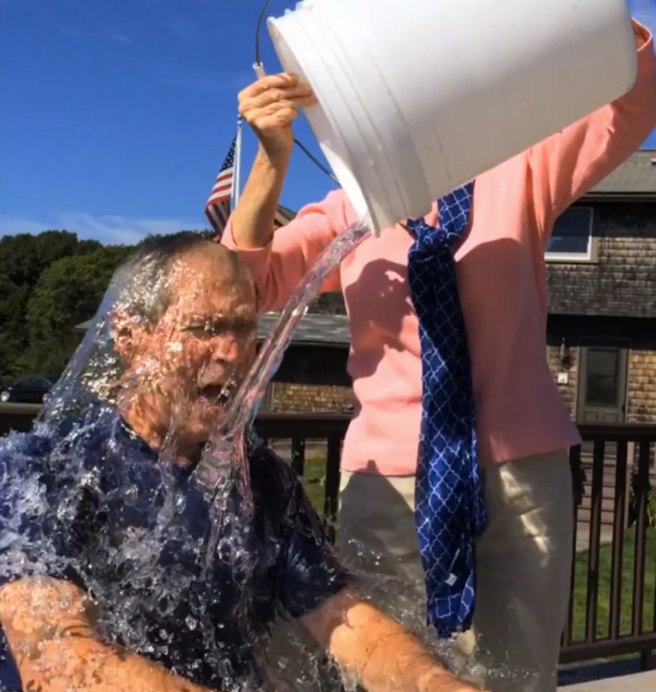Former President George W. Bush participates in the ice bucket challenge with the help of his wife, Laura Bush, in Kennebunkport.
