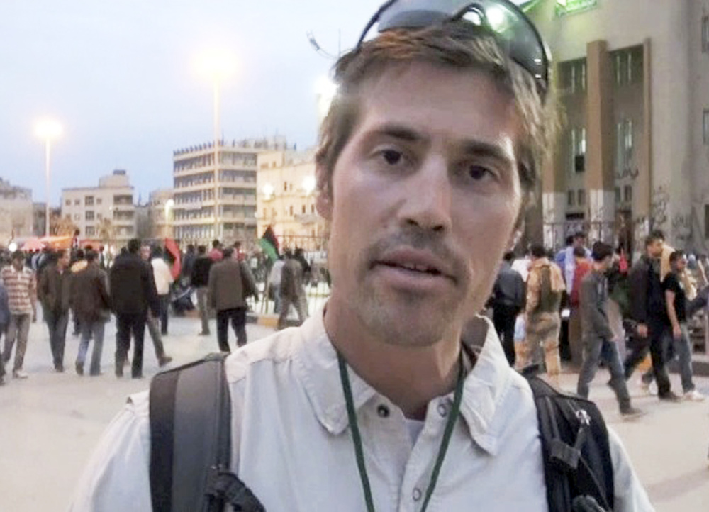 This undated still image from video released April 7, 2011, by GlobalPost, shows James Foley of Rochester, N.H., a freelance contributor for GlobalPost, in Benghazi, Libya. In a horrifying act of revenge for U.S. airstrikes in northern Iraq, militants with the Islamic State extremist group have beheaded Foley — and are threatening to kill another hostage, U.S. officials say.