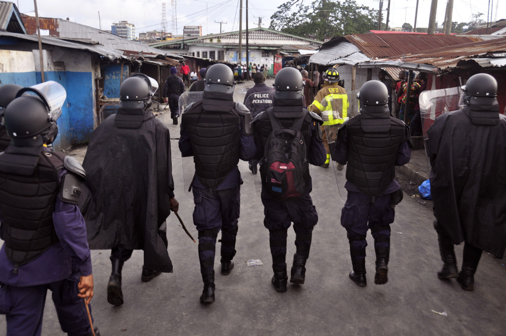 Liberia security forces patrol in the West Point slum. The Associated Press