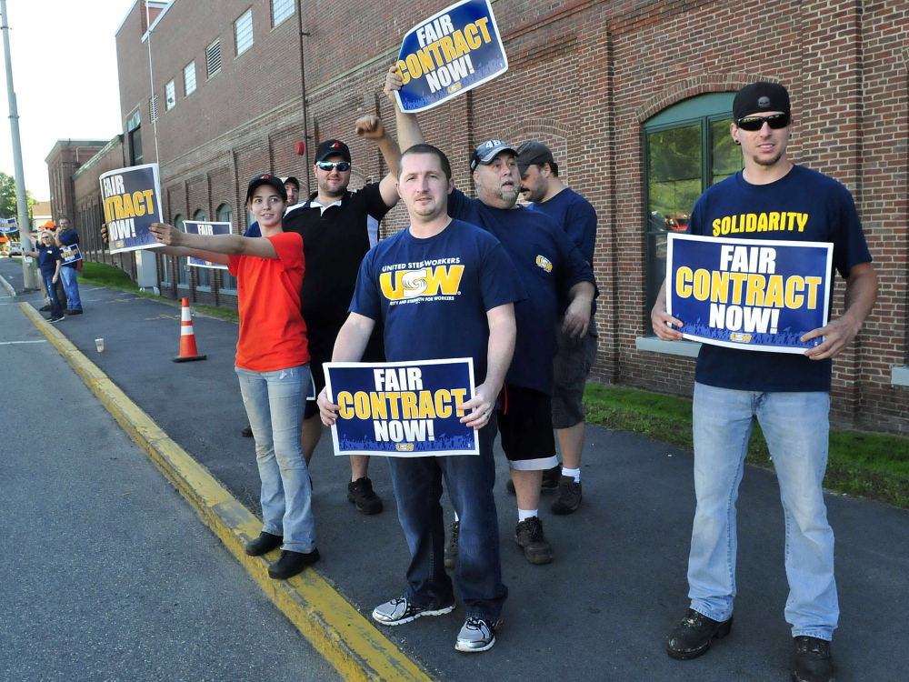 United Steelworkers Local 449 members demonstrate outside the Huhtamaki plant Wednesday in Waterville. Union member Alan Rose, right, said the workers have been without a contract for two years.