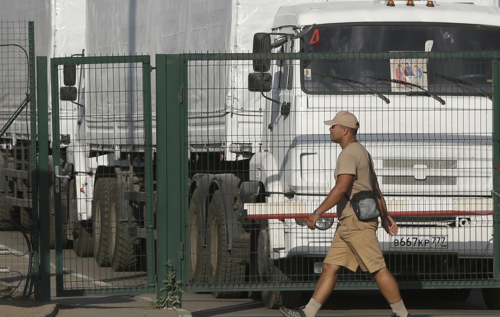First trucks of the Russian aid convoy stand in the Russian inspection zone in the town of Donetsk.