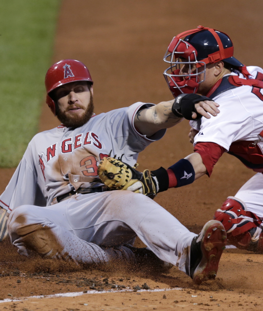 Josh Hamilton of the Los Angeles Angels is tagged out by catcher Christian Vazquez of the Boston Red Sox while trying to score on a single by Howie Kendrick during the first inning of the Angels’ 2-0 victory Thursday night at Fenway Park. The Angels swept the four-game series.