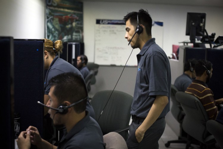 Men work the phones at the Firstkontact Center, a call center in the northern border city of Tijuana, Mexico.