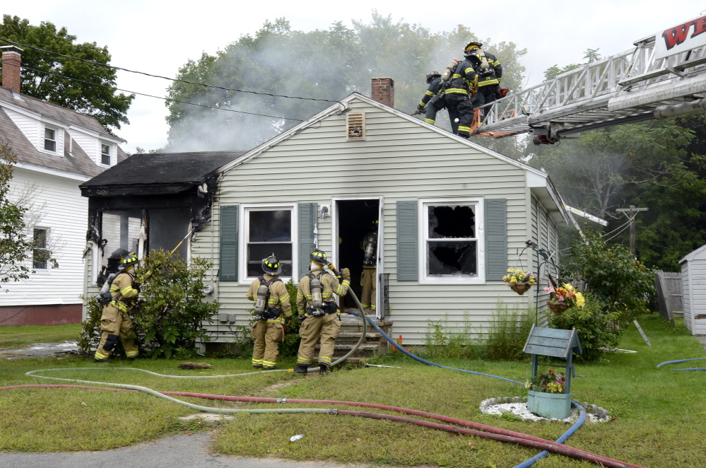 Westbrook firefighters battle a blaze at 40 Myrtle St. in Westbrook on Friday.