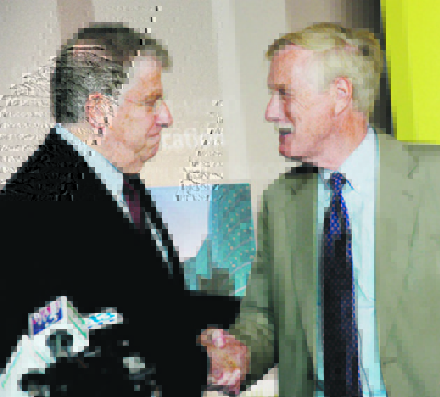 Sen. Angus King, right, shakes hands with independent candidate for governor Eliot Cutler on Monday in Portland.