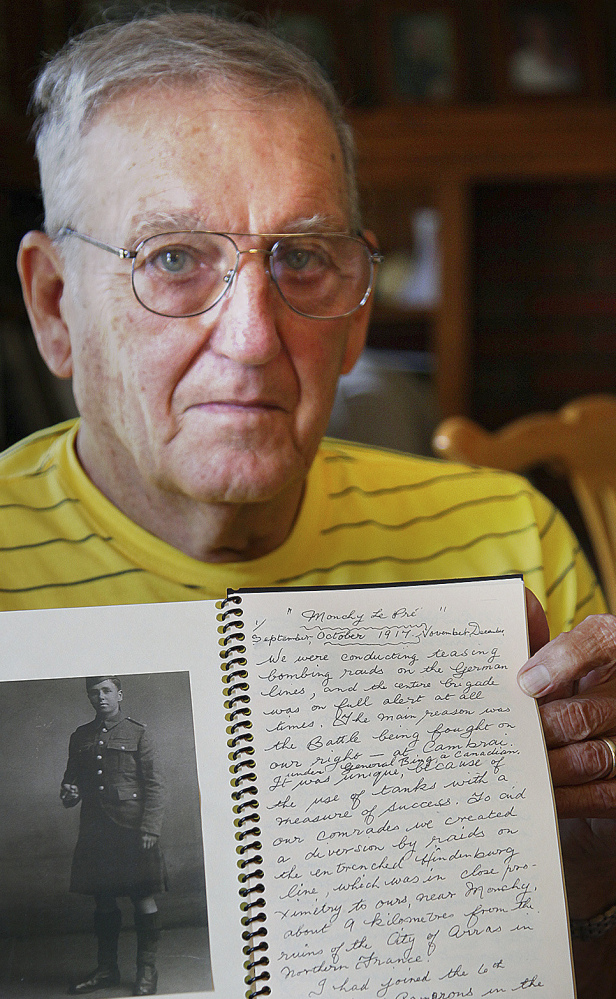 Alexander Scott MacKinlay Jr. of Rockland, Mass., holds a journal left by his father, who fought in World War I. The papers were left in the Quincy house that his sister inherited after their father died in 1984.