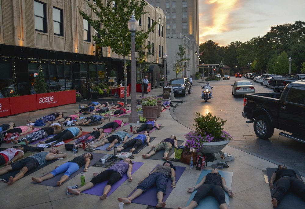 Yoga enthusiasts enjoy a free class at St. Louis’ Maryland Plaza, several blocks south of Delmar Boulevard – the de facto dividing line between the city’s wealthier, majority-white area to the south and the majority-black area north of the east-west boulevard.