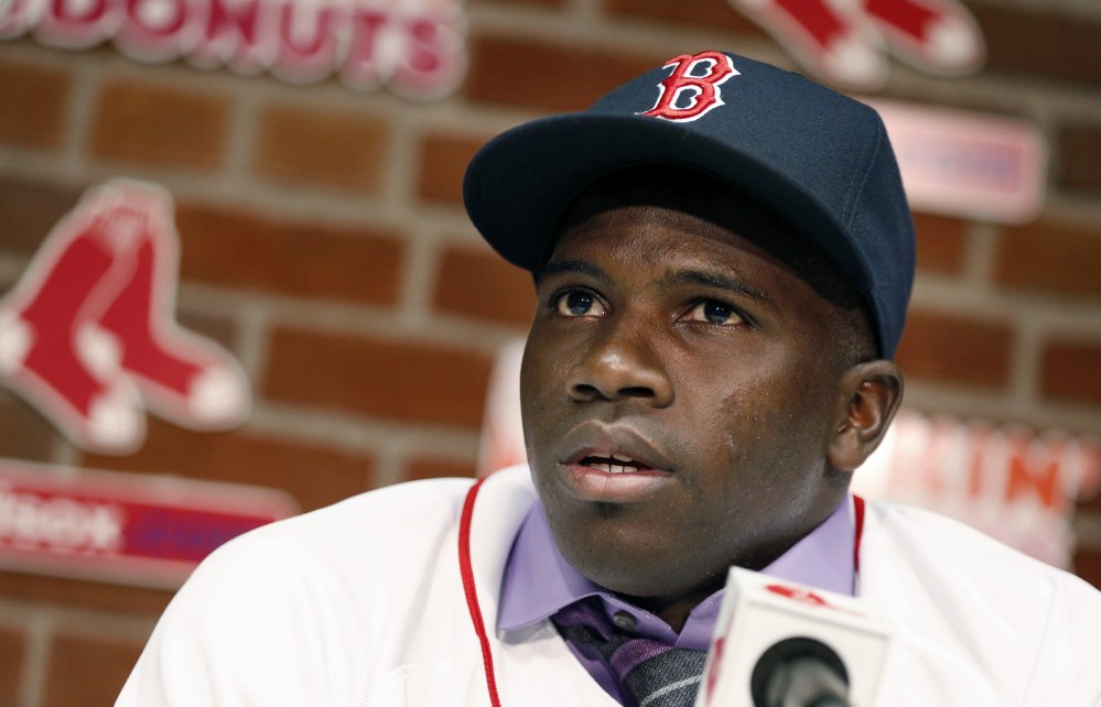 Rusney Castillo talks with reporters Saturday in Boston. The Red Sox announced that they signed Castillo, a Cuban defector, to a seven-year contract, beginning in 2014.
