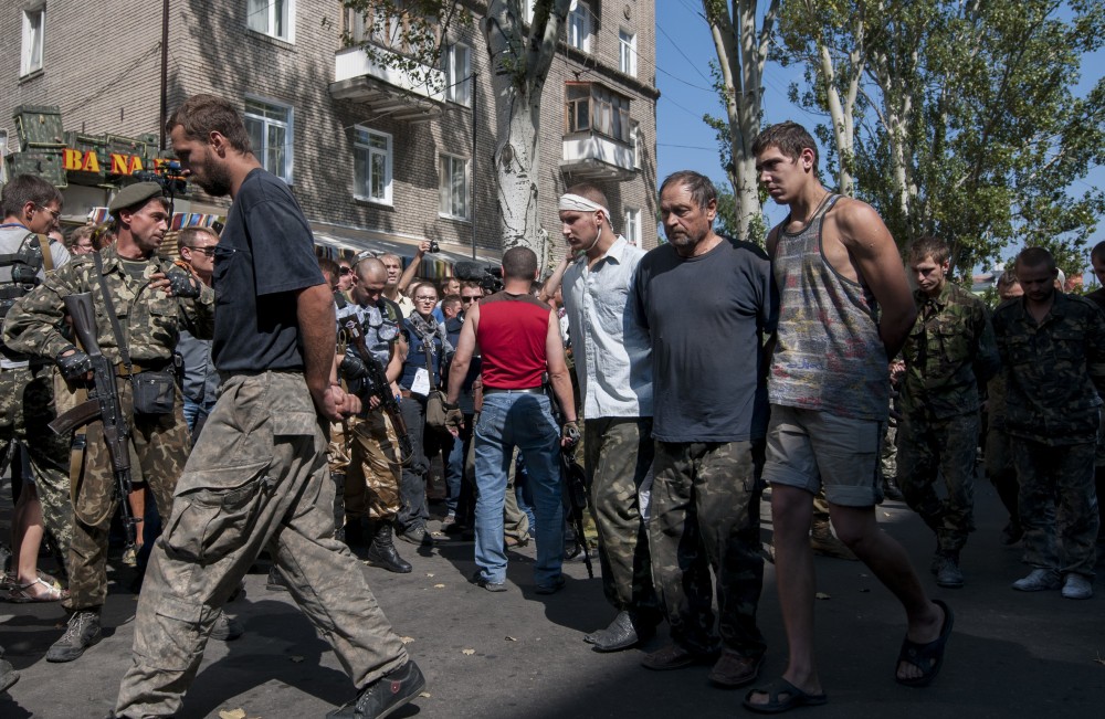 Pro-Russian rebels escort captured Ukrainian army prisoners through a square in Donetsk, eastern Ukraine, on Sunday.