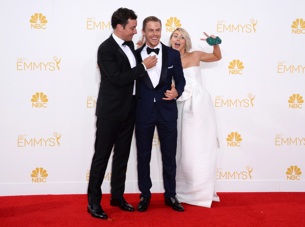 Jimmy Fallon, from left, Derek Hough and Julianne Hough arrive at the 66th Annual Primetime Emmy Awards at the Nokia Theatre L.A. Live on Monday in Los Angeles.