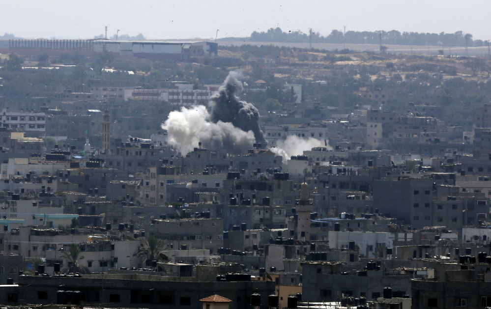 Smoke and dust rise after an Israeli strike hits in Gaza City, northern Gaza Strip, Tuesday.