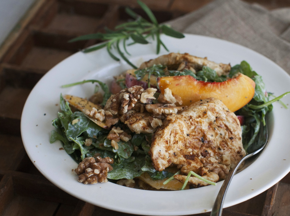 A grilled chicken paillard with peach and arugula salad is a light but filling choice for Labor Day parties.