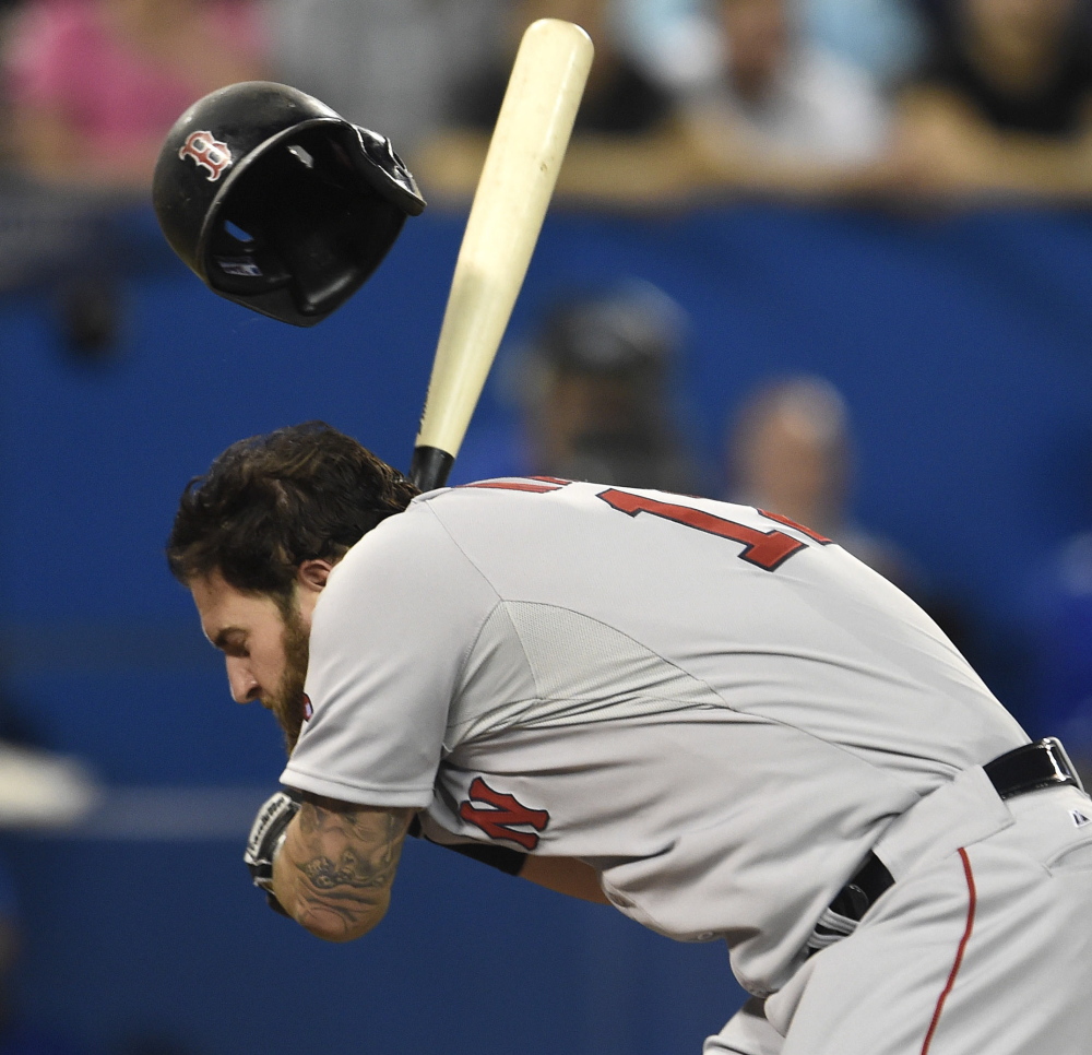Mike Napoli of the Boston Red Sox is hit by a pitch Tuesday night during the fifth inning of an 11-7 victory against the Toronto Blue Jays in 11 innings. Napoli stayed in the game.
