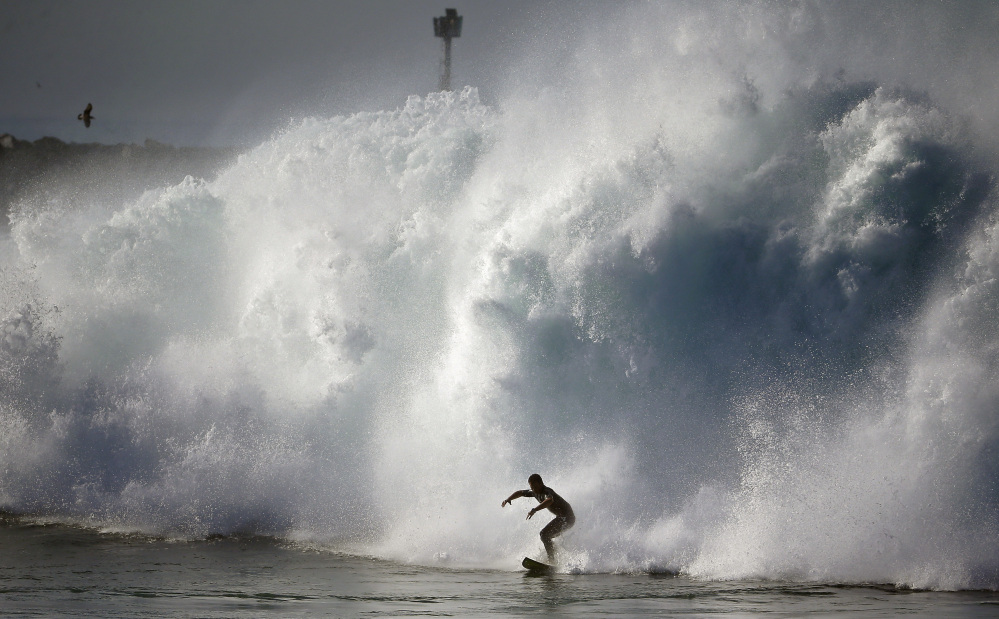 A surfer rides a wave Wednesday at the notorious Wedge in Newport Beach, Calif. Hurricane Marie off the coast of Mexico spawned life-threatening water conditions.