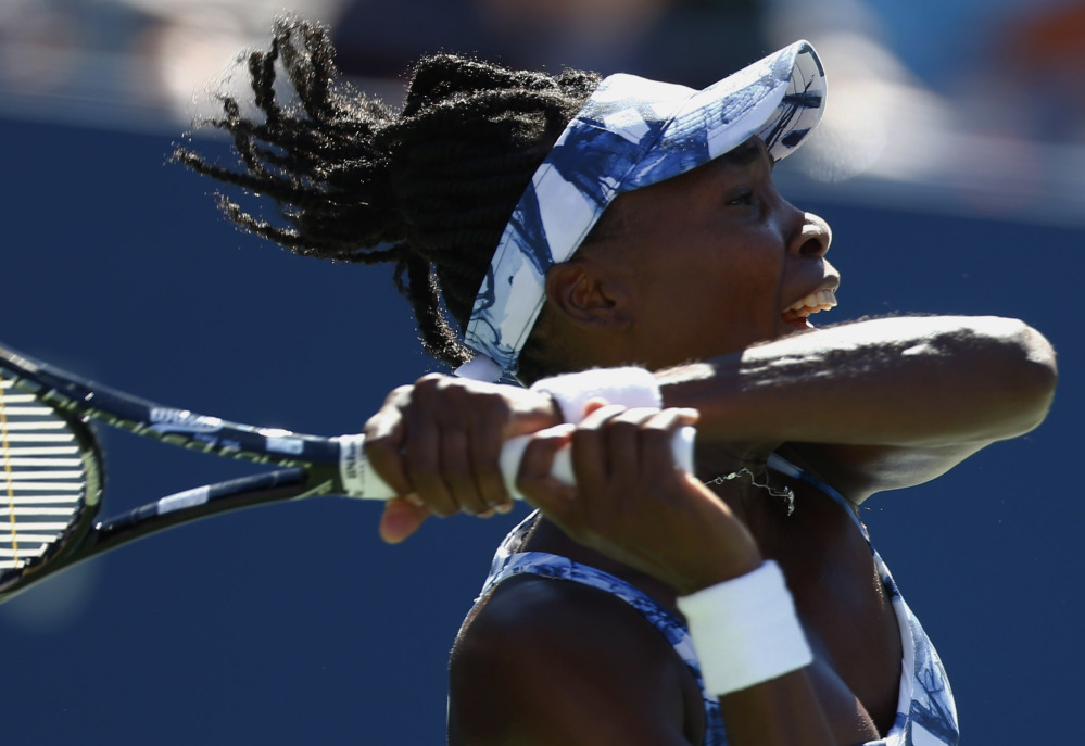 Venus Williams follows through on a shot against Sara Errani on Friday during the third round of the U.S. Open in New York. Williams was eliminated in three sets.