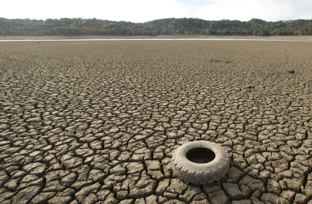 A tire rests on the dry bed of Lake Mendocino in California in February 2014. Some experts considered the drought a preview of the future of climate change. 