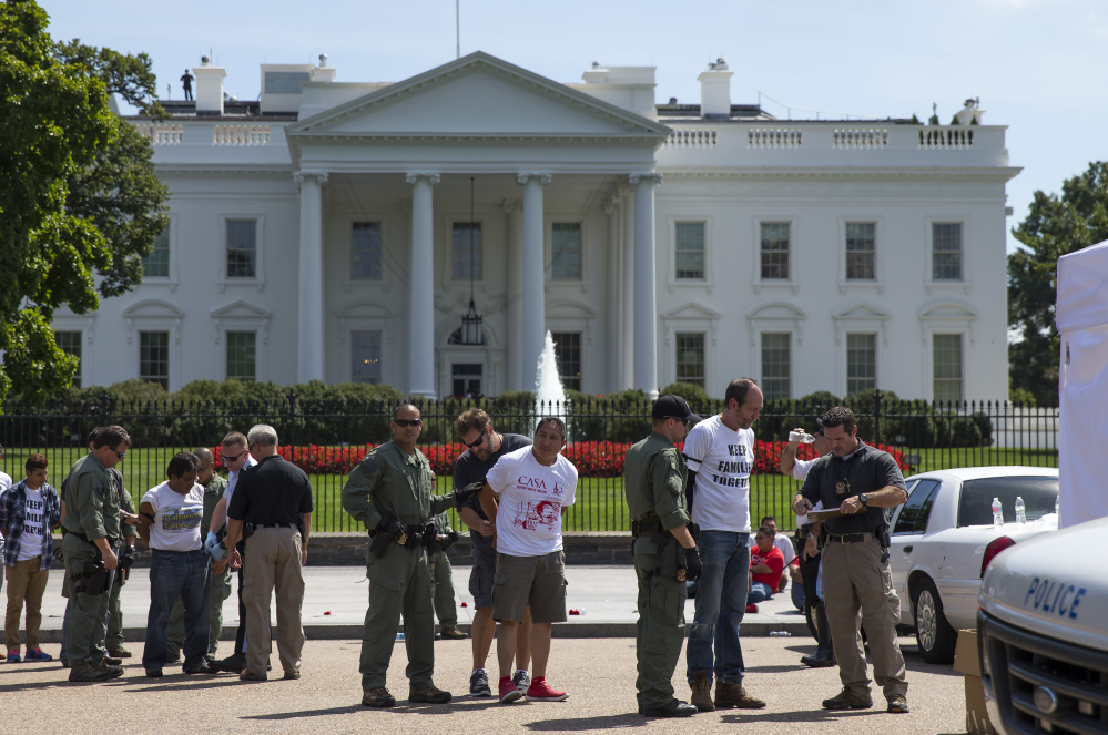 Protesters rally outside the White House over immigration reform Thursday. Reluctant to be seen as stalling for political reasons, the administration suggested that if the decision slips past summer, it would be because of the situation on the border, not the election.