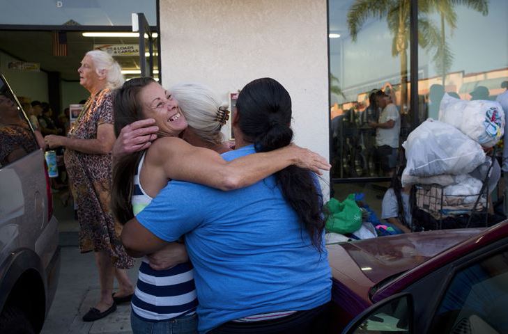 Jeanne Strickler, left, who is homeless, hugs her friends outside a laundromat before a Laundry Love event Aug. 13 in Huntington Beach, Calif. 